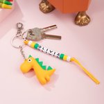 Llavero personalizado con nombre de dinosaurio de dibujos animados de colores Accesorios para mochilas Cumpleaños Vuelta al cole para niños Niñas