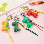 Llavero personalizado con nombre de dinosaurio de dibujos animados de colores Accesorios para mochilas Cumpleaños Vuelta al cole para niños Niñas