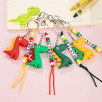 Llavero personalizado con nombre de dinosaurio de dibujos animados de colores Accesorios para mochilas Cumpleaños Vuelta al cole para niños Niñas